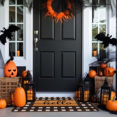 a front door decorated for halloween with pumpkins and lanterns