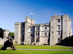 an old castle with a cannon in front of it