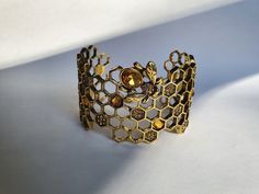 Very beautiful bee bracelet, with a solid but light construction. It is decorated in the center with a bee with rhinestones. It is an accessory of character and can dress up all circumstances. #bracelet #bee #gold #bijoux #bee #gold #jewelry #nature #paris #fashion #honey #flowers #france #handmade #bees #love #flowers #madeinfrance #bees #fashion #photography #faitmain #beekeeping #bijouxcreateur #flower #art #necklace #macro #style #picoftheday Vogue Jewelry Editorial, Bee Accessories, Nature Paris, Bee Bracelet, Vogue Jewelry, Jewelry Nature, Jewelry Editorial, Art Deco Bracelet, Bee Jewelry