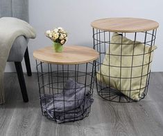 two side tables with wire baskets on them, one has a flower vase and the other is a pillow