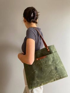 Green Rectangular Canvas Bag For Outdoor, Green Tote Canvas Bag For Outdoor, Green Canvas Tote Bag For Outdoor Use, Coated Canvas Tote Bag With Pockets, Green Waxed Canvas Bags With Pockets, Practical Rectangular Waxed Canvas Bag, Practical Rectangular Canvas Bag With Waxed Finish, Casual Everyday Canvas Bag With Waxed Finish, Green Tote Shoulder Bag For Outdoor