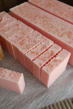 several bars of pink soap sitting on top of a counter