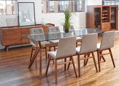 a dining room table with chairs and a plant