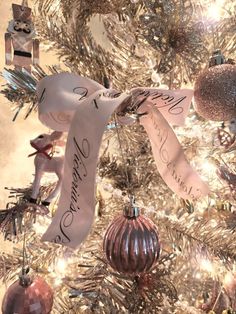 a christmas tree decorated with ornaments and ribbons