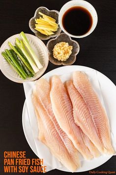 fish fillets on a plate with soy sauce and asparagus