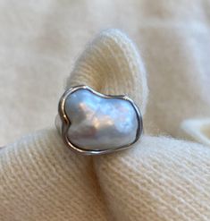 Tiffany & Co Pearl ring in platinum. Size 7 approximately 31 grams Excellent condition Bold band is organically formed while centering a keshi pearl White in body color with strong iridescence and excellent luster Set low and surrounded by a waved but polished platinum edge Stamped PT950 for platinum Signed Peretti and Tiffany & Co. Circa: 1980s Ring Size: 7 & sizable Total weight: approximately 31 grams Fluid. Flowing. Form. Elsa Peretti, Kesha, Keshi Pearls, Platinum Ring, Body Color, Body Colour, Pearl Ring, Tiffany & Co., Pearl White