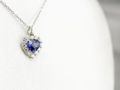 We've set this classic pendant with a deep blue sapphire of excellent quality. The setting is filled with bright white diamonds, reflecting brilliance and life into this gorgeous gemstone. This pendant does not come with the chain shown. Please feel free to contact us, we will help you find the perfect chain for your style and budget! Metal: 18K White Gold Gem: Sapphire 1.03 Carats Gem Measurements: 5.7 x 7.1 mm, Pear Cut Accents: 12 Diamonds totaling .36 Carats, G in Color, VS in Clarity Measurements: 11 x 16 mm, with bail Marks: "18K" Stamped on the reverse Silver Sapphire Necklace With Heart Cut, Sapphire Pendant Necklace With Brilliant Cut, Diamond White Sapphire Pendant Necklace, White Gold Sapphire Heart Pendant Jewelry, Anniversary Sapphire Pendant Diamond Necklace, Sapphire Brilliant Cut Diamond Necklace Gift, Silver Sapphire Heart Pendant Necklace, Sapphire Diamond Necklace With Brilliant Cut As Gift, Gift Sapphire Diamond Necklace With Brilliant Cut