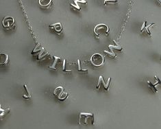 Item Description: *A small sized solid sterling silver letter pendant or charm. *We stock every letter of the alphabet. *Combine letters together to form names, words, places etc. making a truly personal and wonderful gift or keepsake. Materials *925 Sterling Silver. Condition: *New. Dimensions *Letter Pendant Height: Approximately 5mm. *Letter Pendant Width: Varies with each letter. Optional Necklace: *Chain Length: 18, 46cm. *Chain Style: Diamond Cut Belcher. Alternative Necklace: *If you woul Alternative Necklace, Necklaces Silver, Sterling Silver Initial, L Alphabet, Letter Charms, Letter Pendants, Initial Letter, Letter Necklace, Necklace Chain