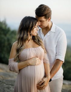 a pregnant couple standing next to each other