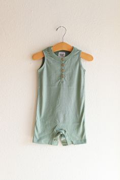 A fresh take on the ultimate summer one piece - the Henley Romper for babies. This lightweight, adorable outfit is as cute as it is functional. Here are the deets:- Super Soft 100% Organic Cotton- Runs true to size.- Pre-Shrunk- Ethically sourced and sustainably produced from a GOTS Certified Organic factory .- Printed using eco-friendly water-based inks.- Super soft, flexible lightweight material.- Metal five snap closure for easy diaper changes- Sewn in label in neckline, hangtag attached Spring Playtime Sleeveless Onesie, Casual Sleeveless Bubble Romper For Summer, Casual Sleeveless Summer Bubble Romper, Sleeveless Summer Onesie, Casual Fitted Bubble Romper For Loungewear, Fitted Cotton Bubble Romper For Loungewear, Summer Cotton Bubble Romper For Loungewear, Cute Solid Color Bubble Romper For Beach, Playful Sleeveless Bodysuit For Playtime