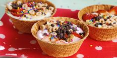 three ice cream cones topped with cereal and sprinkles on a red tray