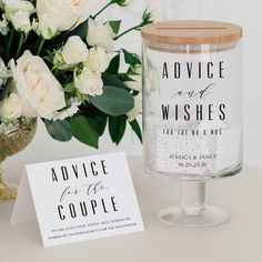 there is a vase with flowers and a card on the table next to it that says advice for the couple