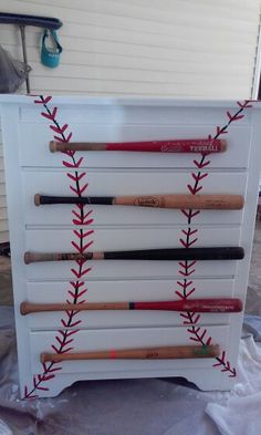 a baseball themed dresser with many bats on it