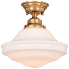 a light fixture with a white glass shade on the bottom and gold trimmings