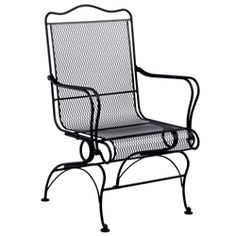 a black wrought iron chair with armrests and foot rests on an isolated white background