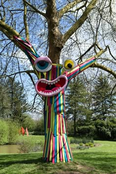 a paper mache sculpture in the shape of a tree with its mouth open and tongue out