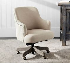 an office chair sitting on top of a carpeted floor next to a wooden cabinet