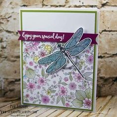 a card with a dragonfly on it and some flowers in the background that says enjoy your special day