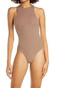 Sculpt your body's natural shape with a high-neck bodysuit from Kim Kardashian West's SKIMS that holds you in and lifts you up in all the right places. Reflecting the brand's passion for highly technical shapewear solutions for every body, this everyday piece has whisper-soft, seamless construction, high-cut legs and a thong back that remains invisible under clothing. Style Name:Skims Fits Everybody High Neck Bodysuit (Regular & Plus Size). Style Number: 6125046. Sleek Second-skin Turtleneck Bodysuit, Sleek Turtleneck Second-skin Bodysuit, Sleek High Stretch Turtleneck Bodysuit, Sleek High-stretch Turtleneck Bodysuit, High Neck Smoothing Bodysuit In Solid Color, High Stretch Seamless Bodysuit Shapewear, Seamless High Stretch Bodysuit Shapewear, Seamless Minimal Stretch Bodysuit Shapewear, High Stretch Seamless Shapewear Bodysuit