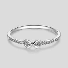 "So elegant is this infinity style diamond ring, perfect for everyday wear as the diamond gives just the right amount of sparkles to your finger. Absolutely perfect for any occasion and stacks well with other ring styles. Ring features: Metal: Available in solid white, yellow, or rose gold 14k. - Ring Width: Approximately 1.3 mm - Diamond Shape: Round - Number of Stones: 18 of Mined Diamond (100% Real Diamonds ) - Diamond Size: 1.1 mm - Total CTW: 0.08 Ctw - Diamond Color-Clarity: G - H Color SI Infinity Stackable Rings For Wedding, Infinity Stackable Wedding Rings, Elegant Infinity Diamond Promise Ring, Half Eternity Infinity Ring For Anniversary, Formal Sterling Silver Infinity Diamond Ring, Wedding Infinity Diamond Ring, Elegant Infinity Rings With Half Eternity Detail, Classic Infinity Diamond Ring For Anniversary, Elegant Infinity Eternity Band As A Gift