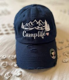 Welcome to my shop! This women's camping hat comes in a few different color options and is embroidered with high quality thread! If you have any questions or would like to change thread colors please send me a message! Thank you for stopping by! Camping Hat, Hat Ponytail, Design Camp, Womens Hats, Stylish Caps, Camp Life, Ponytail Hat, Women Camping, Embroidered Hat