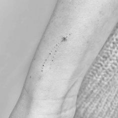 a small star tattoo on the left ankle, with tiny stars all over it's body