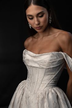 a woman in a white dress posing for the camera