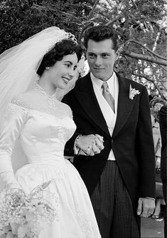 a bride and groom standing next to each other