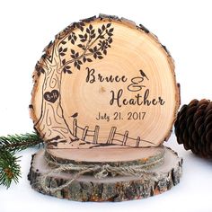 a personalized wood slice with a tree on it and pine cones next to it