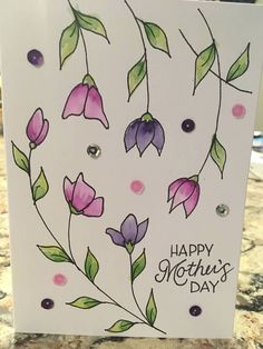 a handmade mothers day card with purple flowers