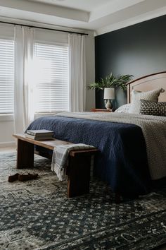 a bedroom with a bed, bench and window