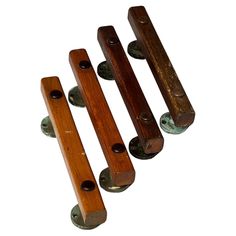 three wooden handles with metal knobs on them