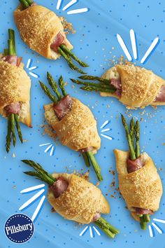 asparagus wrapped in puff pastry on a blue plate with sprinkles