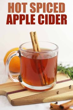 hot spiced apple cider in a mug with cinnamon sticks