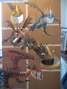 a cardboard box that has several different types of dragon heads on it