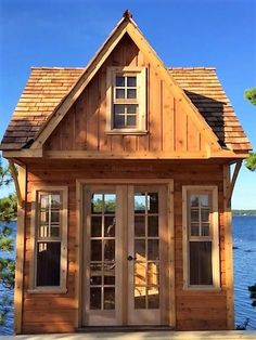 a small wooden house sitting on top of a lake