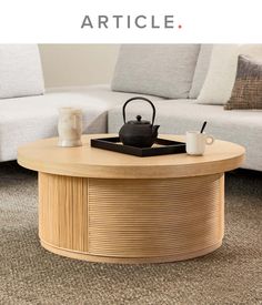 a coffee table with a teapot on top and the words article written below it