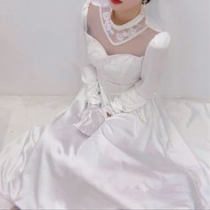 a mannequin dressed in a white dress and headpiece