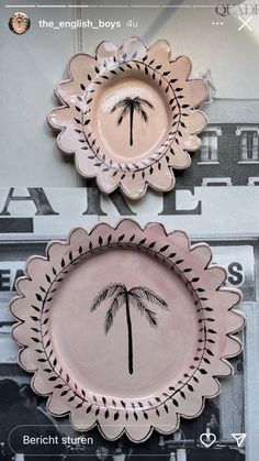 two plates with palm trees painted on them, one is pink and the other is black