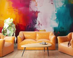 a living room with two couches and a coffee table in front of a colorful painting