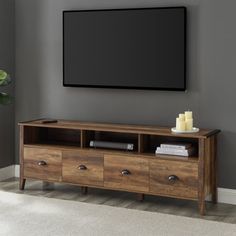 an entertainment center with a flat screen tv mounted on the wall