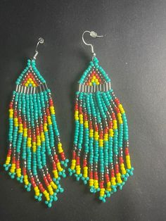 Beaded seed beaded and bugle beads  dangle multi colored earrings on silver fish hooks with rubber backings Colorful Tiny Beads Dangle Earrings, Colorful Nickel-free Beaded Drop Earrings, Colorful Nickel-free Dangle Beaded Earrings, Multicolor Tiny Beads Drop Earrings, Nickel-free Colorful Dangle Beaded Earrings, Colorful Dangle Earrings With Tiny Beads, Multicolor Dangle Jewelry With Tiny Beads, Multicolor Dangle Beads With Ear Wire, Multicolor Dangling Beads Drop Earrings