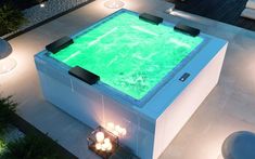 an outdoor hot tub is lit up with green algae in the water and surrounded by lights