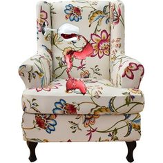 an upholstered chair with a lamp on it's arm and floral fabric