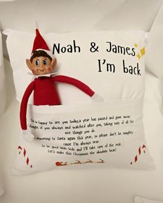 a pillow with an elf on it that says, noah & james i'm back