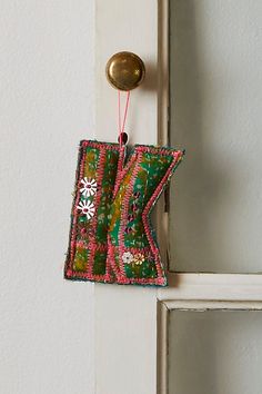 an ornament hanging from the side of a door handle on a white door