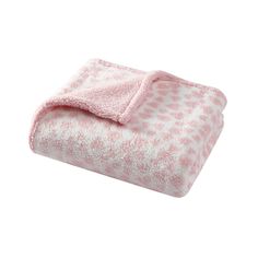 a pink and white blanket with polka dots on it