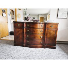 a large wooden dresser sitting on top of a carpeted floor