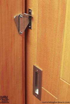 a close up of a wooden door with a metal handle on the front and side