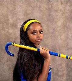 a girl with long hair holding a baseball bat